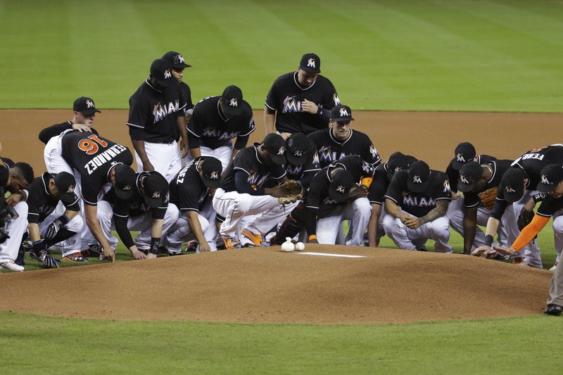 The Associated Press MOURNING TOGETHER: Miami Marlins wear #16 jerseys as they stand around the pitching mound during a pre-game ceremony honoring pitcher Jose Fernandez before a baseball game against the New York Mets on Monday. Fernandez died in a boating accident Sunday.