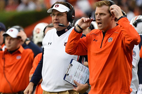 In this Nov. 21, 2015, file photo, Auburn coach Gus Malzahn, left, and offensive coordinator Rhett Lashlee, right, watch the action against Idaho during the first half of an NCAA football game in Auburn, Ala. Malzahn, who built his career on offensive play calling and creativity, has finally handed over the reins to let offensive coordinator Rhett Lashlee call plays. (AP Photo/Mark Almond, File)

