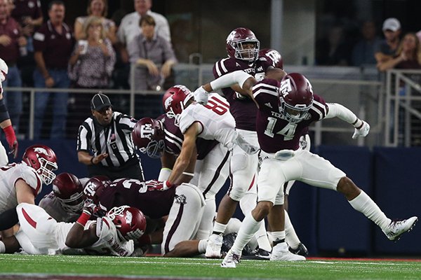 Texas A&M defenders celebrate after making a goal line stop in the fourth quarter of a game against Arkansas on Saturday, Sept. 24, 2016, in Arlington, Texas. 