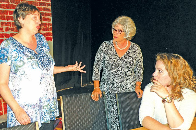 Heather Stringfellow, left, appearing as juror No. 8 in 12 Angry Women, gives her opinion on evidence presented in the murder trial of a 19-year-old man in this rehearsal scene from the upcoming Center on the Square production. Listening to her opinions are Nancy Liles, center, who appears as juror No. 4, and Lauren Lawson, right, who appears as juror No. 10. Center on the Square in Searcy will present the play in October.