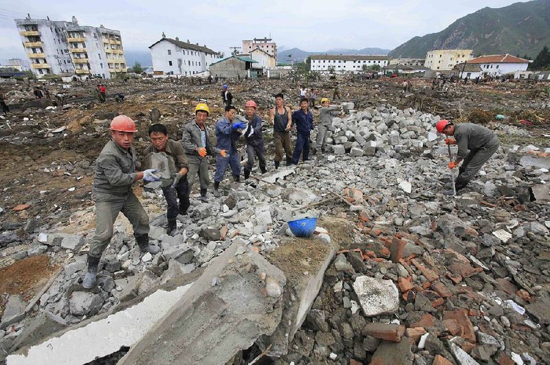 North Korean workers salvage concrete blocks from a flood-damaged area earlier this month. “The disaster was pretty horrendous for the people affected,” Chris Staines, head of the International Federation of Red Cross and Red Crescent Societies in North Korea, said Wednesday. 