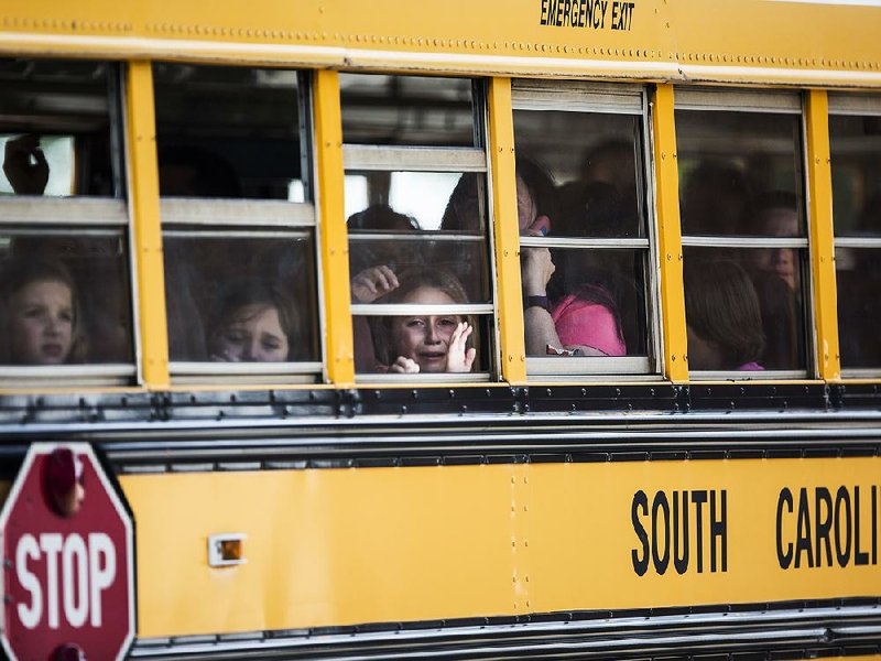 Students wait to be moved from Townville Elementary in Townville, S.C., on Wednesday after a shooting at the school that left two students and a teacher wounded. The teen gunman killed his father earlier, police said. 