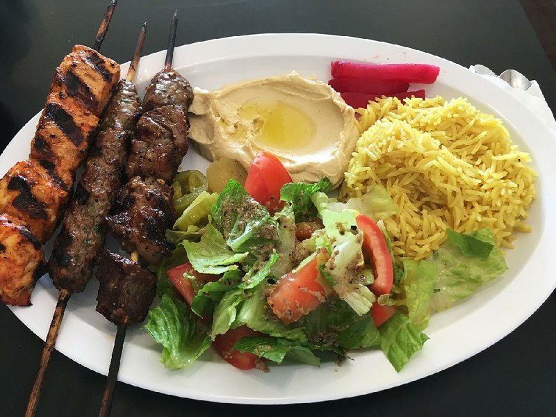 The Zam Zam Special Platter features three kebabs — (from left) Shish Taouk, Kofta and Ribeye — with hummus tahini, Greek salad and rice. 