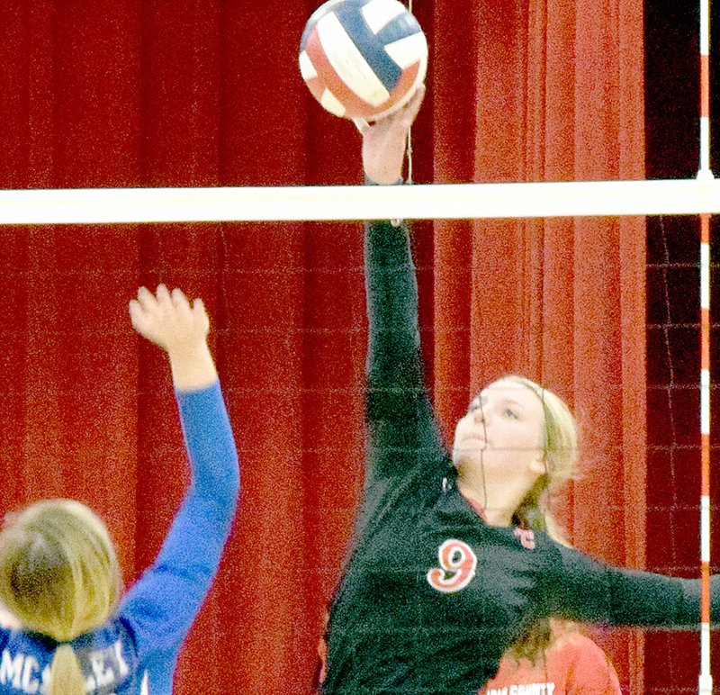 PHOTO BY RICK PECK McDonald County&#8217;s Alex Gross tips the ball over the net for a point in the Lady Mustangs 25-8, 25-14 win over Joplin McAuley on Sept. 19 at MCHS.