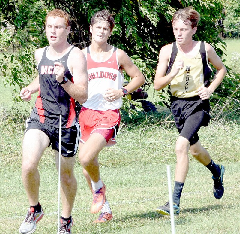 PHOTO BY RICK PECK McDonald County&#8217;s Truman Craig (left) finished in 31st place out of a field of 150 runners at Saturdays East Newton Cross Country Invitational at East Newton High School to lead the Mustangs to a sixth place in the team standings.