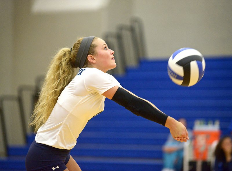 Emily Doss of Springdale Har-Ber makes a dig on Sept. 1 during a match against Rogers in King Arena at Rogers.