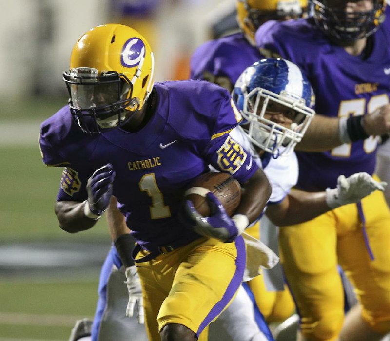 Arkansas Democrat-Gazette/STATON BREIDENTHAL --9/29/16--  Catholic's Samy Johnson (left) runs past Bryant defender AJ Williams for a touchdown Thursday night during their game  at War Memorial Stadium.