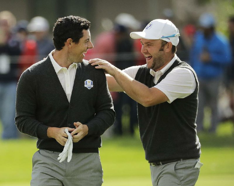 European Ryder Cup teammates Rory McIlroy (left) and Andy Sullivan (right) encouraged a heckler to put up or shut up when they both missed putts on the 12th hole during a practice round Thursday at Hazeltine National Golf Club in Chaska, Minn. The heckler made the putt, and Justin Rose lost $100.