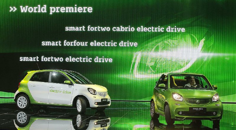 Smart fortwo electric compact cars are displayed Thursday at the Paris auto show. Major automakers are displaying several new zero-emission electric cars at the show. 