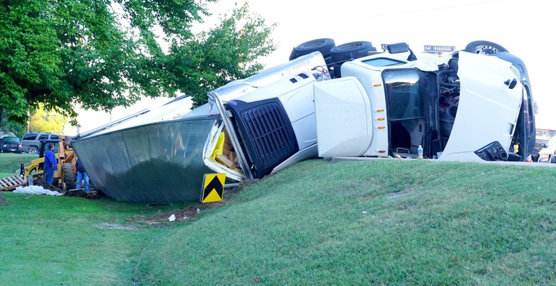 A tractor-trailer rig hauling packaged product overturned on a curve on Arkansas Highway 12 at Pioneer Lane in the predawn hours of Thursday. Cleanup had to be paused for heavy school traffic but was then resumed.