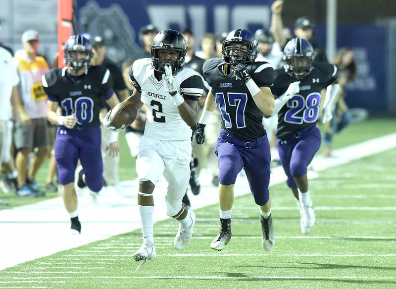 Bentonville receiver Kam’ron Mays-Hunt (2) outruns Fayetteville defenders on his way to the end zone Sept. 23 in Fayetteville.