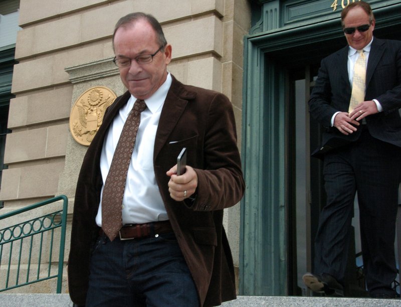 In this Nov. 3, 2014 file photo, Tim Blixseth, left, leaves a U.S. courthouse after facing questions about his finances in Butte, Mont.