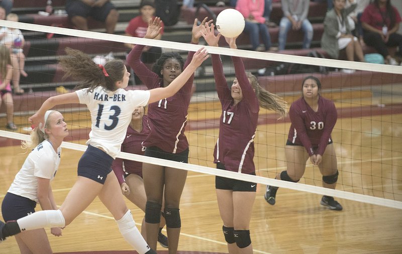 Har-Ber’s Jaden Williams (13) gets the ball past Springdale’s Zoe Schmidt (17) and Keke Turner (11) on Thursday at Bulldog Arena in Springdale.