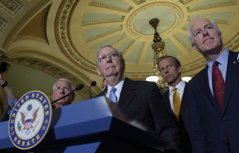  In this Sept. 13, 2016 file photo, Senate Majority Leader Mitch McConnell of Ky., second from left, standing with, from left, Sen. Roger Wicker, R-Miss., Sen. John Thune, R-S.D., and Senate Majority Whip John Cornyn, of Texas, listens to a question during a news conference on Capitol Hill in Washington.