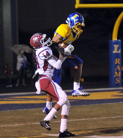 The Sentinel-Record/Mara Kuhn UP FOR GRABS: Lakeside' Kelen Bland goes up for a pass against Hope in a Ram victory last year at Austin Field. Lakeside is home tonight against Magnolia while Hot Springs goes to Hope for Class 5A conference games. Other games tonight involving Garland County teams are Nashville at Fountain Lake, Lake Hamilton at Texarkana, Cutter Morning Star at Quitman and Jessieville at Glen Rose. Mountain Pine, scheduled to play at Mineral Springs, forfeited for the third time this season.