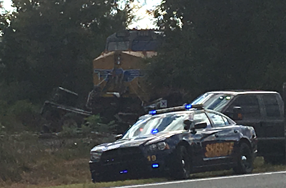 Authorities respond to the scene after a freight train hit a truck just south of U.S. Highway 64 in Conway County.