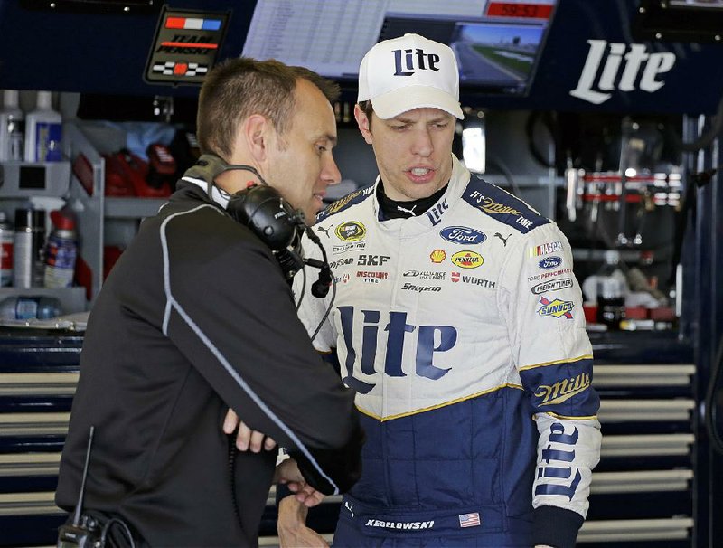 Brad Keselowski, right, talks with his crew chief Paul Wolfe during a practice session for the NASCAR Daytona 500 auto race at Daytona International Speedway, Saturday, Feb. 13, 2016, in Daytona Beach, Fla. 