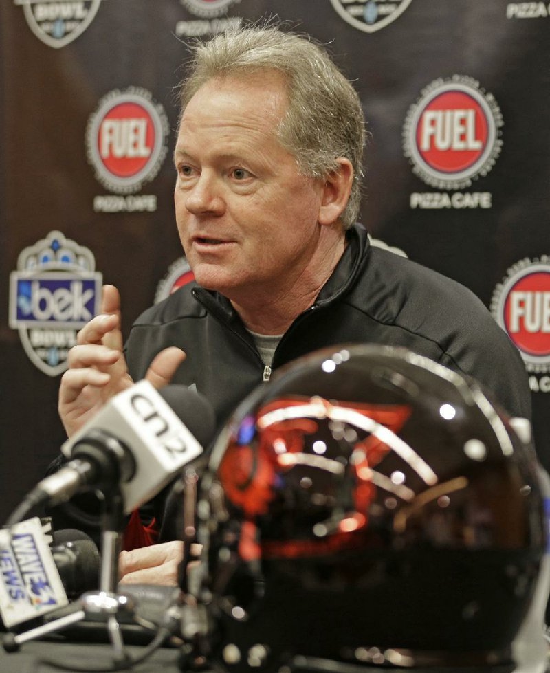 Louisville head coach Bobby Petrino answers a question during a news conference for the Belk Bowl NCAA college football game in Charlotte, N.C., Monday, Dec. 29, 2014. 