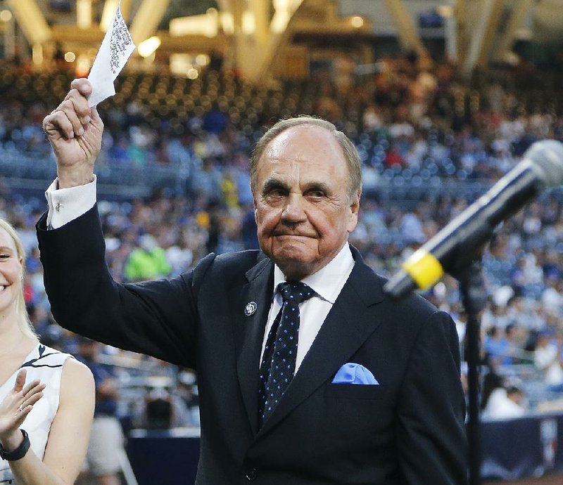 San Diego Padres broadcaster Dick Enberg waves to crowd at a retirement ceremony prior to the Padres final home baseball game of the season, against the Los Angeles Dodgers on Thursday, Sept. 29, 2016, in San Diego. 