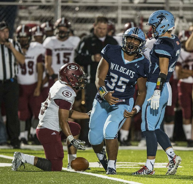 Springdale Har-Ber’s Oliver Nasilai (35) celebrates after tackling Springdale’s Erick Mendez for a loss during Friday night’s game.