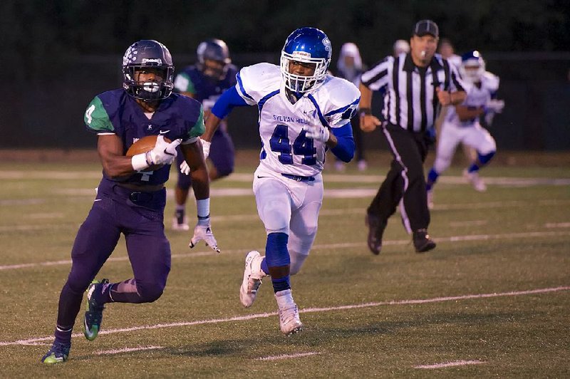 Little Rock Christian Academy running back Ladarius Burnes  tries to outrun Sylvan Hills linebacker Ty Compton during first-half action at LRCA on Friday September 30, 2016. Special to the Democrat Gazette/photo by Matt Johnson