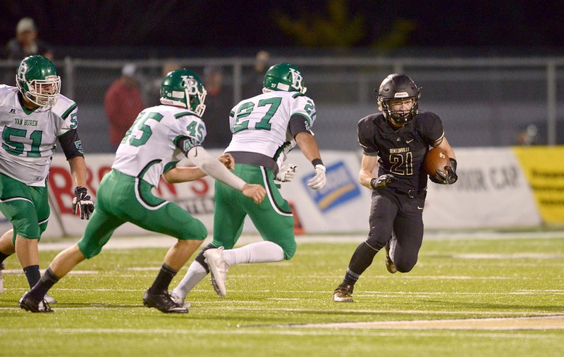 Bentonville wide receiver Harrison Campbell evades Van Buren defenders Isaac Lipe (27), Alex Needham (45) and Jayden Mendez (51) on Friday at Bentonville's Tiger Stadium.