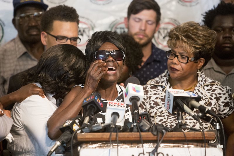 Pamela Benge, center, spoke of her son, Alfred Olango, at a press conference on Thursday Sept. 29, 2016, in San Diego, Calif., to address the killing of Olango, a Ugandan refugee shot by an El Cajon police officer on Tuesday. In an emotional appearance before reporters, Benge said her son Alfred was joyful and loving and was not mentally ill. 