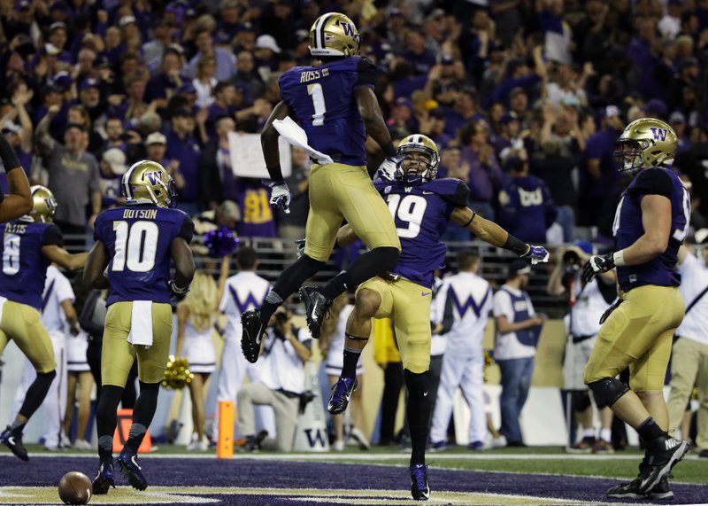 Washington wide receiver John Ross (1) celebrates with wide receiver Andre Baccellia (19) after Ross caught a pass for a touchdown against Stanford in the first half of an NCAA college football game, Friday, Sept. 30, 2016, in Seattle.