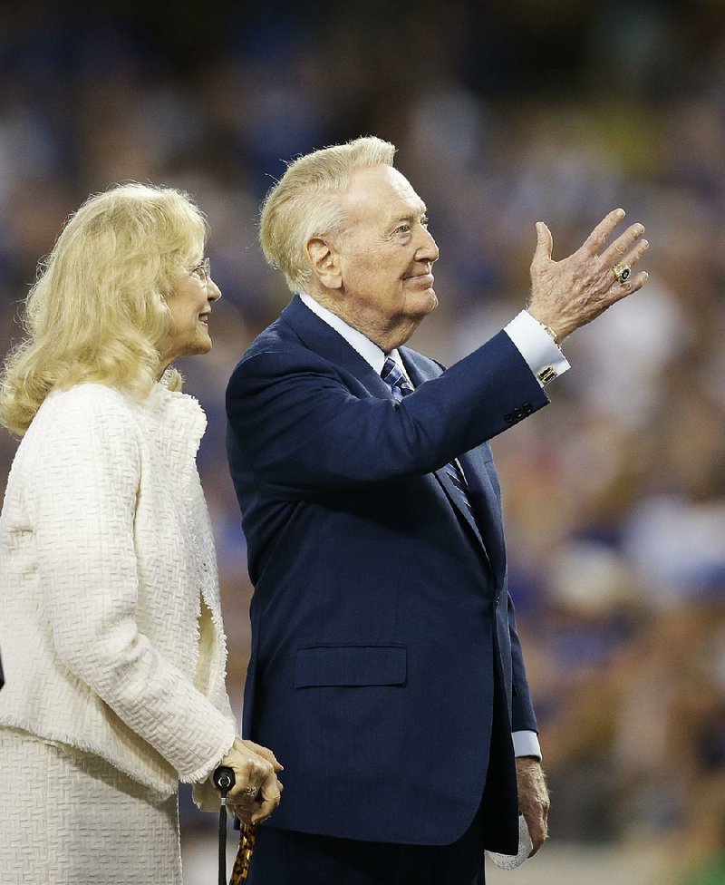 Los Angeles Dodgers broadcaster Vin Scully said he always sought the approval of his wife, Sandi, (left) when making a decision whether or not to return for another year.