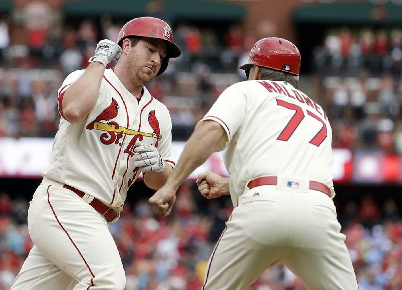 Jedd Gyorko (left) hit a solo home run in the eighth inning to give the St. Louis Cardinals a 4-3 victory over the Pittsburgh Pirates on Saturday at Busch Stadium in St. Louis. The Cardinals trail San Francisco by one game for the final wild-card spot in the National League.