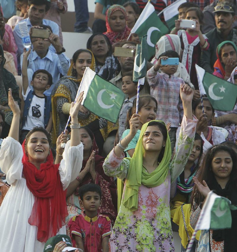 Pakistanis show their patriotism Saturday during the daily ceremony at the Wagha crossing on Pakistan’s border with India. Thousands of Pakistanis turned out for the event.