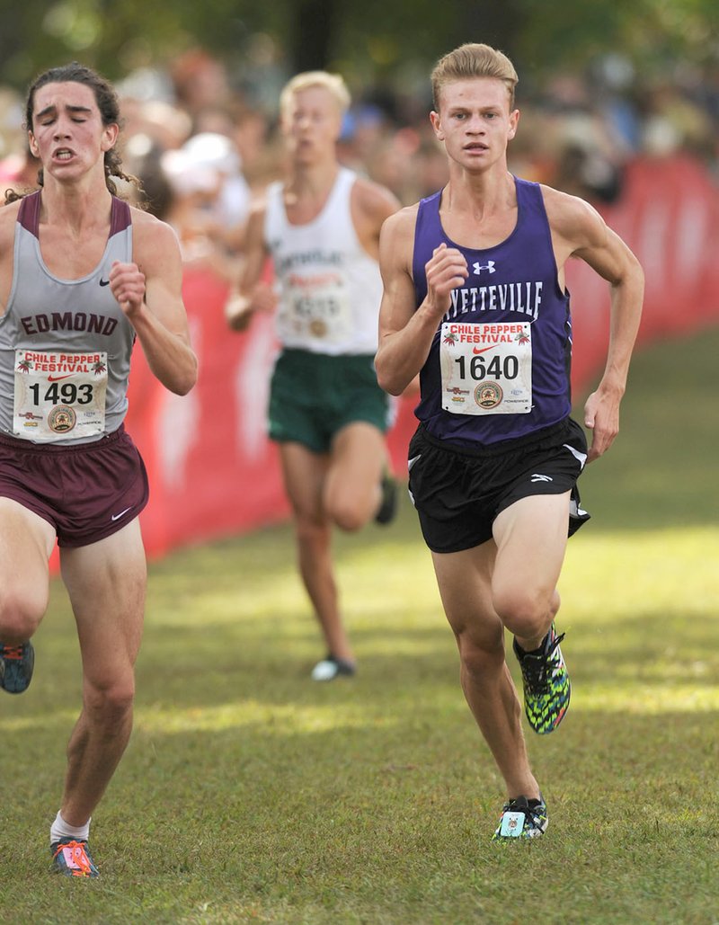 Fayetteville’s Camren Fischer (right) sprints toward the finish line Saturday during the 28th annual Chile Pepper Cross Country Festival at Agri Park in Fayetteville.