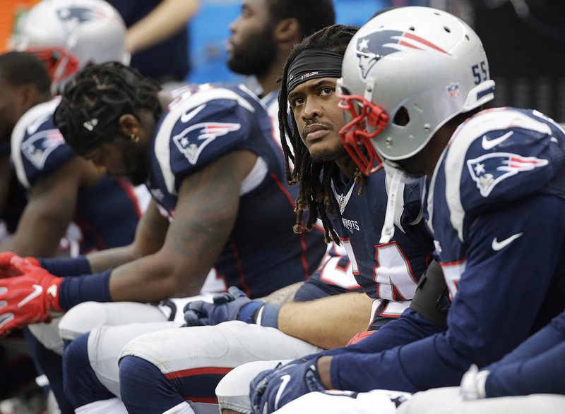 New England Patriots linebackers Jamie Collins (left), Dont’a Hightower (center) and Jonathan Freeny sit on the bench during the second half of Sunday’s game against Buffalo in Foxborough, Mass. The Bills beat the Patriots 16-0, the Patriots’ fi rst shutout loss at home since Gillette Stadium opened in 2002.