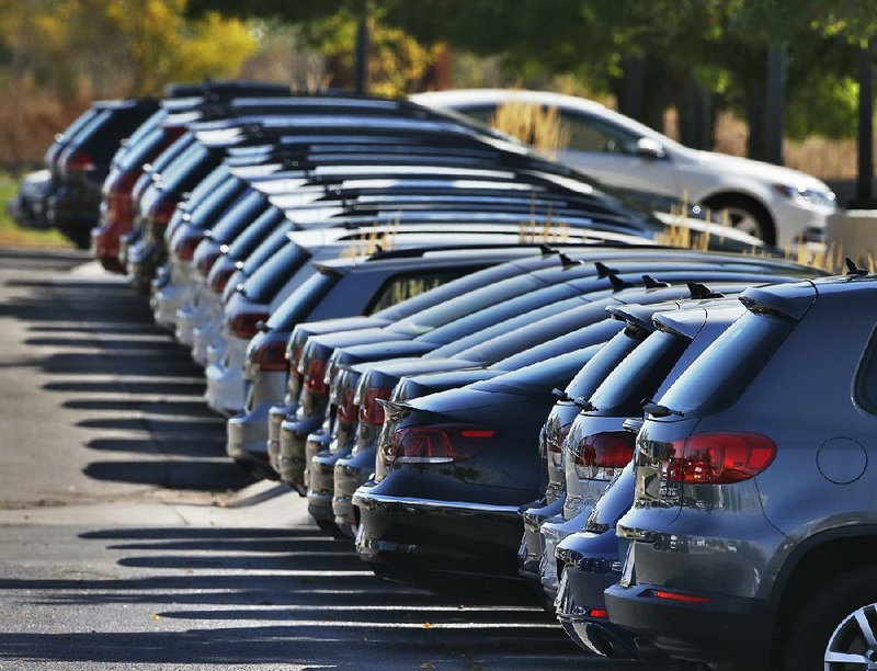 New Volkswagens are displayed at a dealership in Boulder, Colo., in September. Automakers on Monday reported slight sales decreases last month.