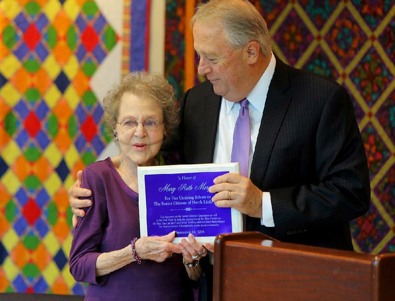 Mary Ruth Morgan (left) accepts a plaque in honor of her service on North Little Rock’s Senior Citizens Commission from NLR Mayor Joe Smith on Sept. 26.