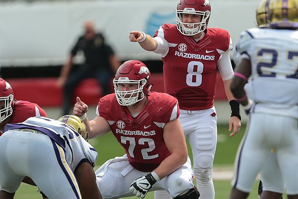 Arkansas' Austin Allen and Frank Ragnow point to blocking assignments before a play during the second quarter of the NCAA football game against Alcorn St. on Saturday, Oct. 1, 2016, in Little Rock, AR. Arkansas beat Alcorn St., 52-10. (AP Photo/Chris Brashers)

