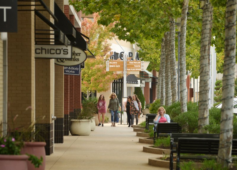 Shoppers walk Monday at Pinnacle Hills Promenade mall in Rogers.