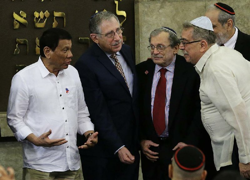 Philippine President Rodrigo Duterte (left) talks with members of the Jewish Association of the Philippines on Tuesday during his visit to the Beit Yaacov Synagogue in Makati, south of Manila.