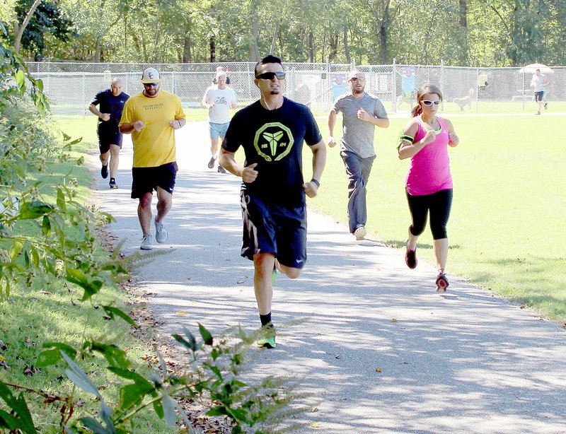 Keith Bryant/The Weekly Vista The police department&#8217;s applicants run along the trail at the Loch Lomond recreation area.