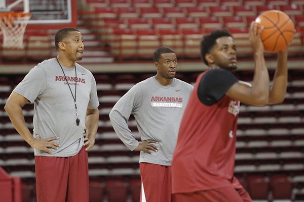 Arkansas assistant coaches Scotty Thurman, left, and TJ Cleveland watch practice Wednesday, Oct. 5, 2016, at Bud Walton Arena in Fayetteville. 