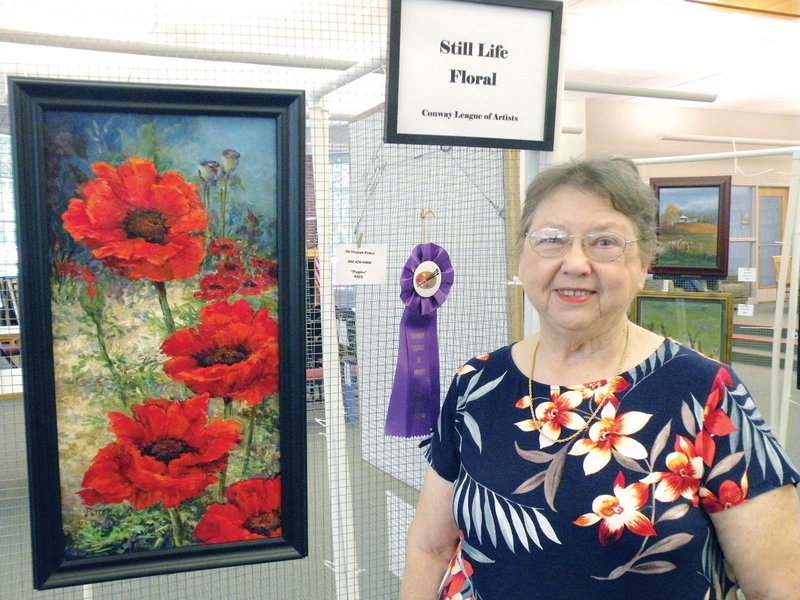 Virginia Potter of Conway won the Best of Show award in the Conway League of Artists Fall Show with her oil on canvas work Poppies. The show will continue through Wednesday at the Faulkner County Library in Conway.