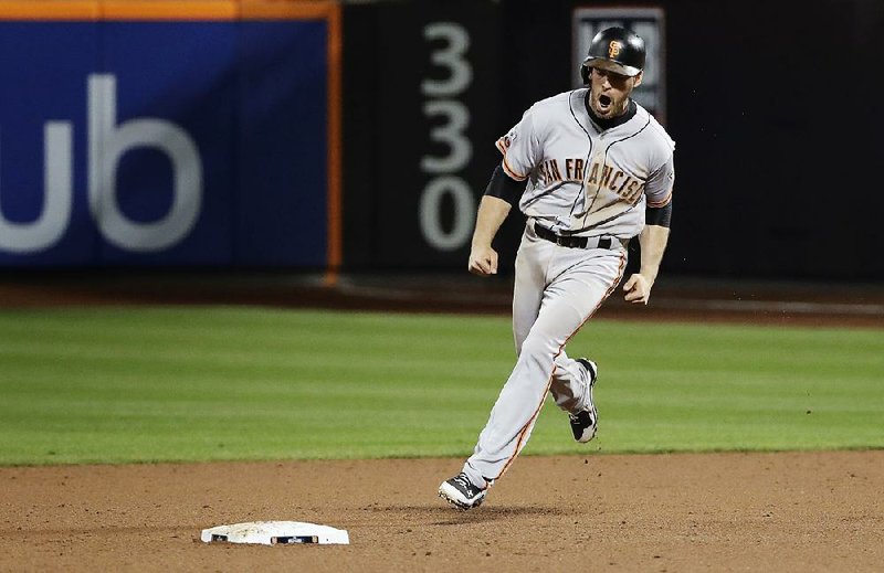 Conor Gillaspie of the San Francisco Giants celebrates after hitting a three-run home run against the New York Mets in the ninth inning of Wednesday night’s National League wild-card game. The Giants won 3-0 to advance to the NL division series.