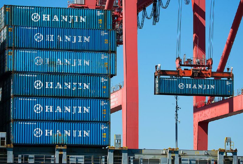 A container is unloaded from the Hanjin Gdynia cargo ship berthed at the Port of Long Beach in Long Beach, Calif., in September. The U.S. trade deficit rose 3 percent in August, the Commerce Department said Wednesday. 