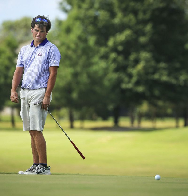 Miles Smith of Little Rock Catholic reacts after missing a putt on the seventh hole Wednesday during the Class 7A boys state golf tournament at Centennial Valley Country Club in Conway. Smith shot a 1-under 71 to claim medalist honors over Cabot’s Connor Gaunt. 