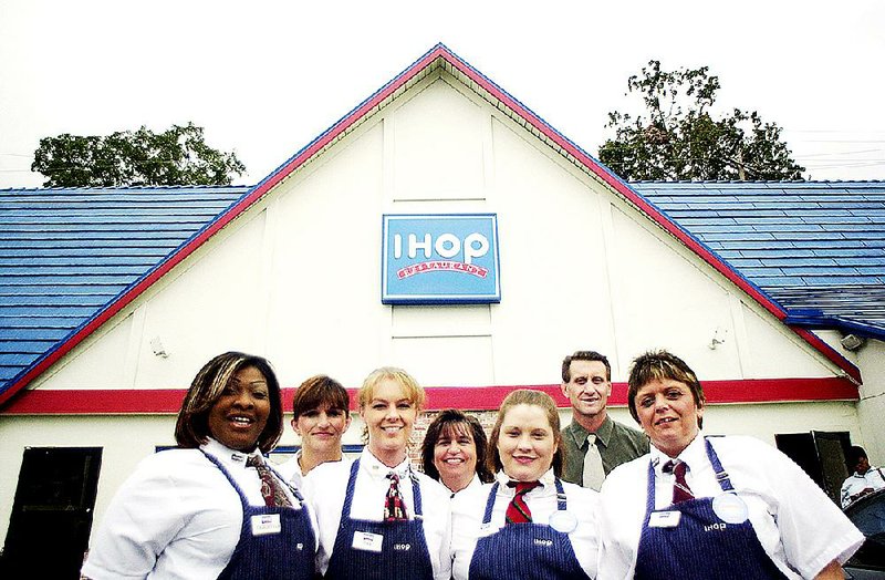 Employees pose in front of the IHOP at West Markham Street and University Avenue in Little Rock in 2003. The building was demolished this week to make way for a new one. 