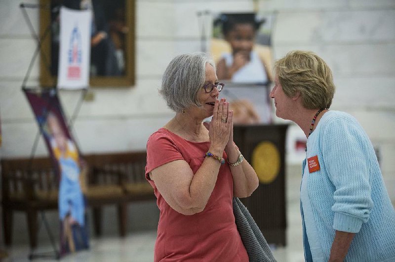 Ann Patterson (left), a child and family advocate, and Patty Barker, director of the Arkansas No Kid Hungry Campaign, talk Wednesday before a news conference held by Arkansas Advocates for Children and Families and the Kids Count Coalition at the state Capitol. 