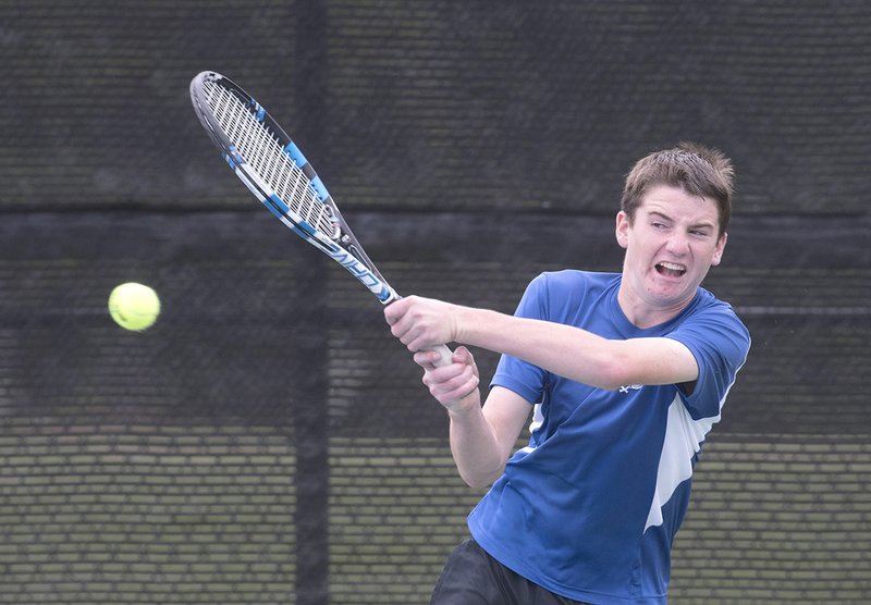 Rogers High’s Payne Henry returns a volley Wednesday at the 7A-West Tennis Tournament in Bentonville.