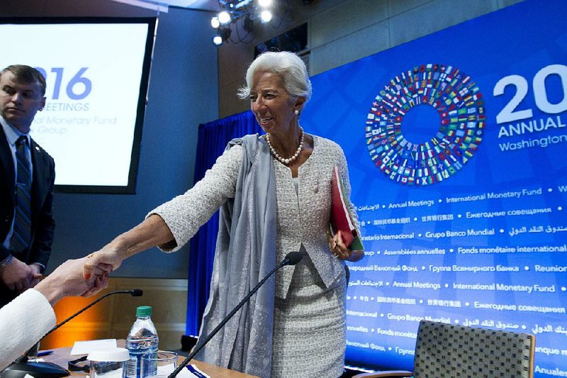 International Monetary Fund Managing Director Christine Lagarde greets a participant after a news conference Thursday during the World Bank/IMF Annual Meetings at IMF headquarters in Washington. 