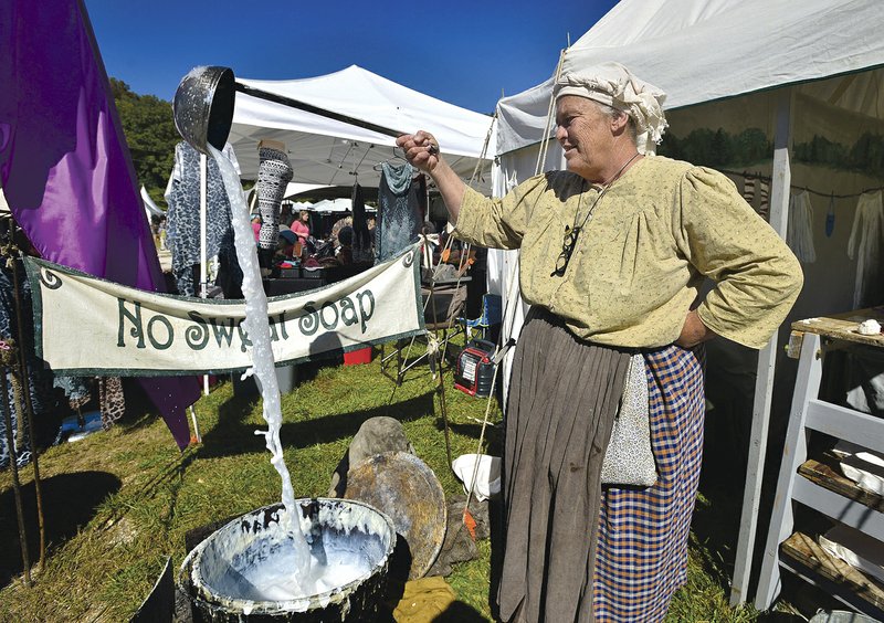 Deborraha Burnett of Mountain View stirs a batch of lye soap in her booth during the Spanker Creek Farm Arts &amp; Crafts Festival last year. This year's event starts Wednesday.