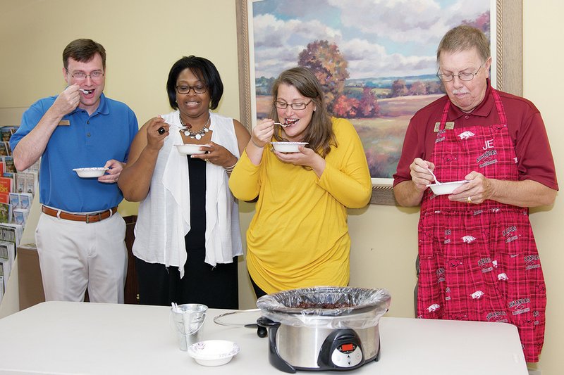 Tasting a chocolate-cherry cobbler made in a crockpot are, from left, Lance Howell, executive director of the Malvern/Hot Spring County Chamber of Commerce; Elesa Cooper-Jones, third-year chamber board member representing the Hot Spring County Homeless Coalition; Jennifer Eubanks, chamber administrative assistant; and Danny Riggan, immediate past chairman of the chamber board of directors.